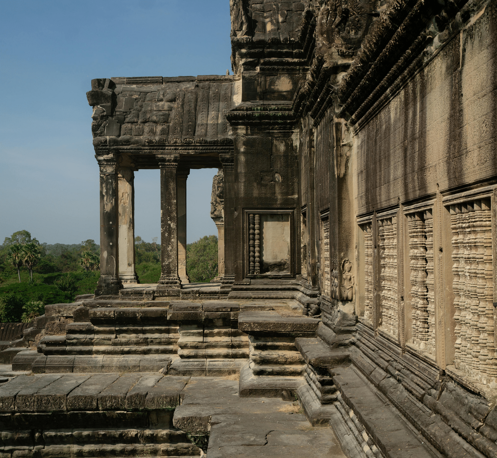 A historic stone edifice with intricate carvings showcases arched doorways and detailed columns.