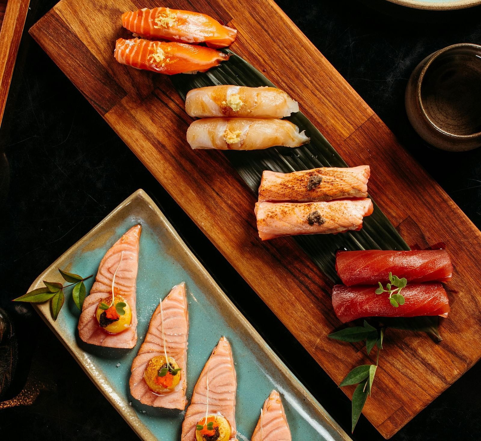 top angle shot of a sushi platter served with soy sauce