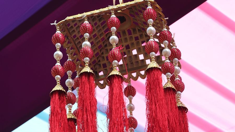 Hanging red tassel decor under a multicoloured canopy at Tisya Farms, Gurgaon.