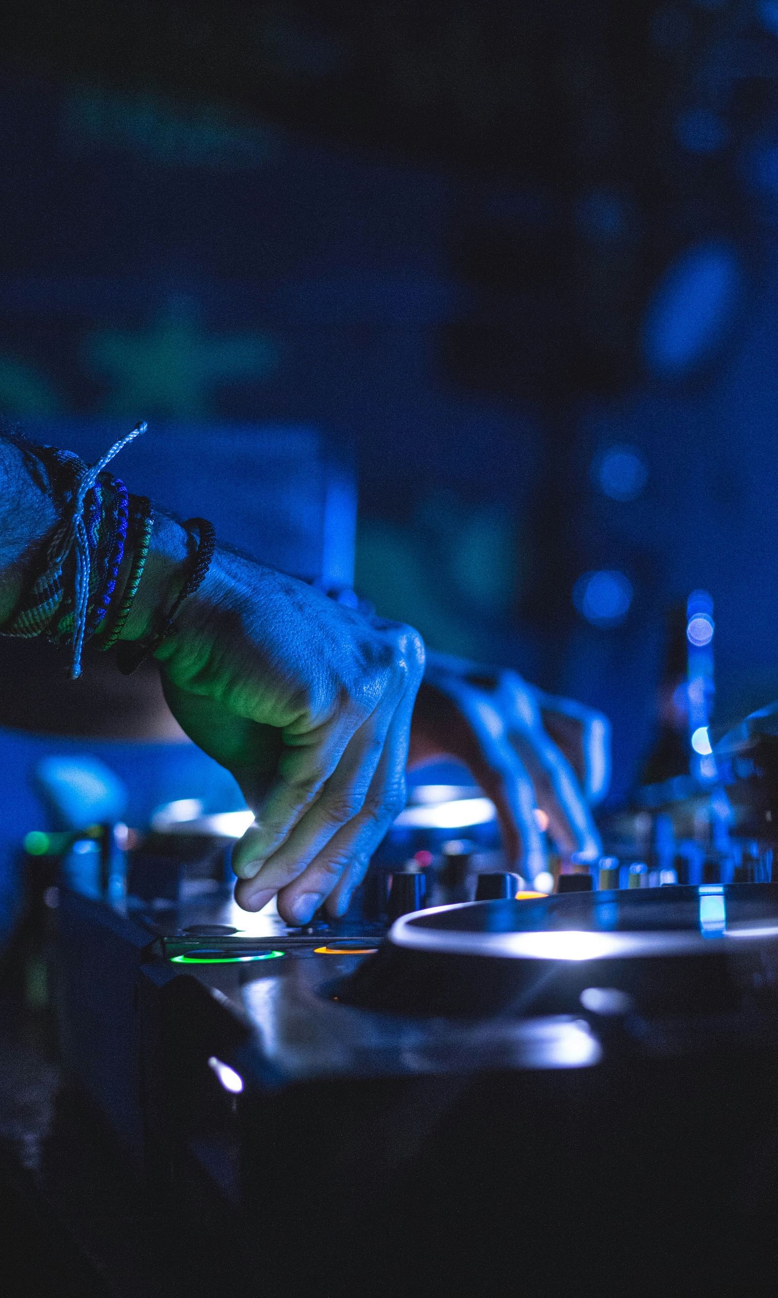  Under the disco lights, the DJ expertly manipulates the beats on his device, creating a pulsating rhythm that energises the dance floor.