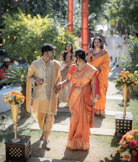 Bride and groom receiving a traditional wedding welcome with floral decor and ceremonial arrangements at the Flora Hill venue | YAAN Udaipur