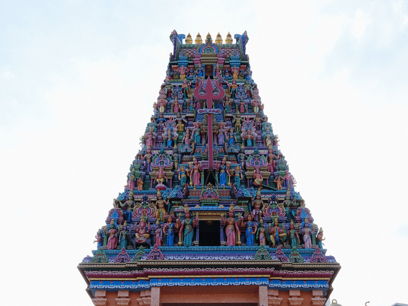 Majestic entrance view of Marudhamalai Temple showing the steep concrete stairs leading up to the colorful gopuram.