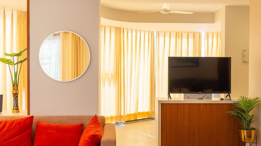 Living area of the Standard Room with a TV behind the sofa at Montclair Ananta, Elite.