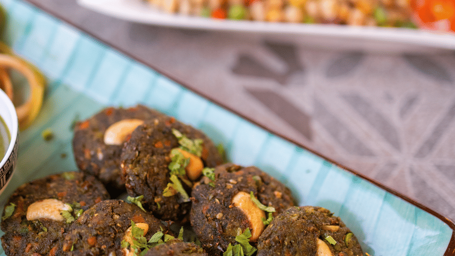 View of cutlets or kebabs on a blue plate with garnishing at Pravasa Stay Luv Kush, Indore.