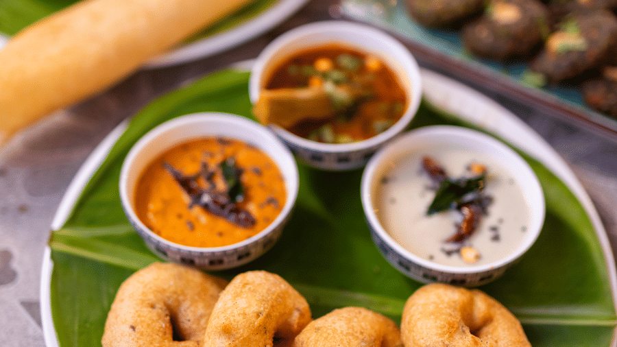 View of South Indian food, including idli or vada, on a banana leaf at Pravasa Stay Luv Kush, Indore.