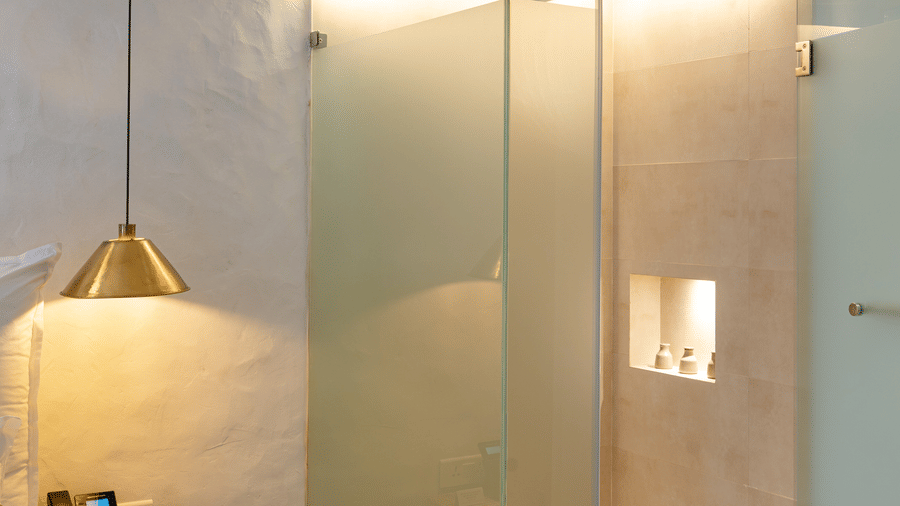 A deluxe loft room with the shower area with glass panels - The Nanee