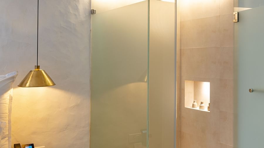 A deluxe loft room with the shower area with glass panels - The Nanee