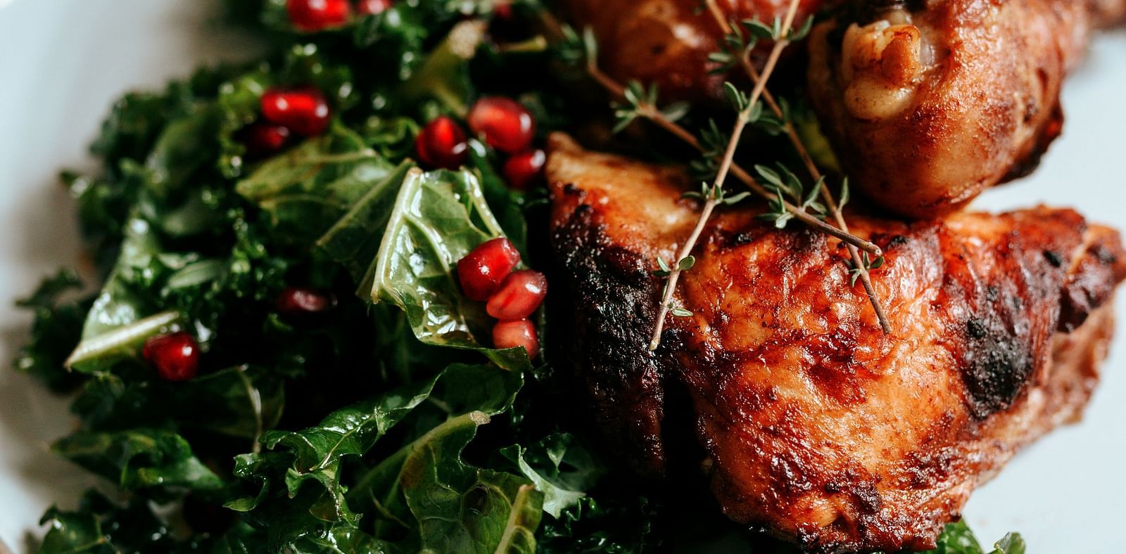 Roasted chicken garnished with fresh herbs.