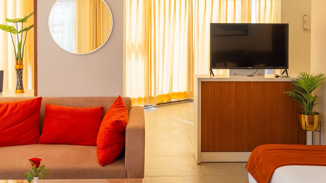 Living area of the Standard Room with a TV behind the sofa at Montclair Ananta, Elite.