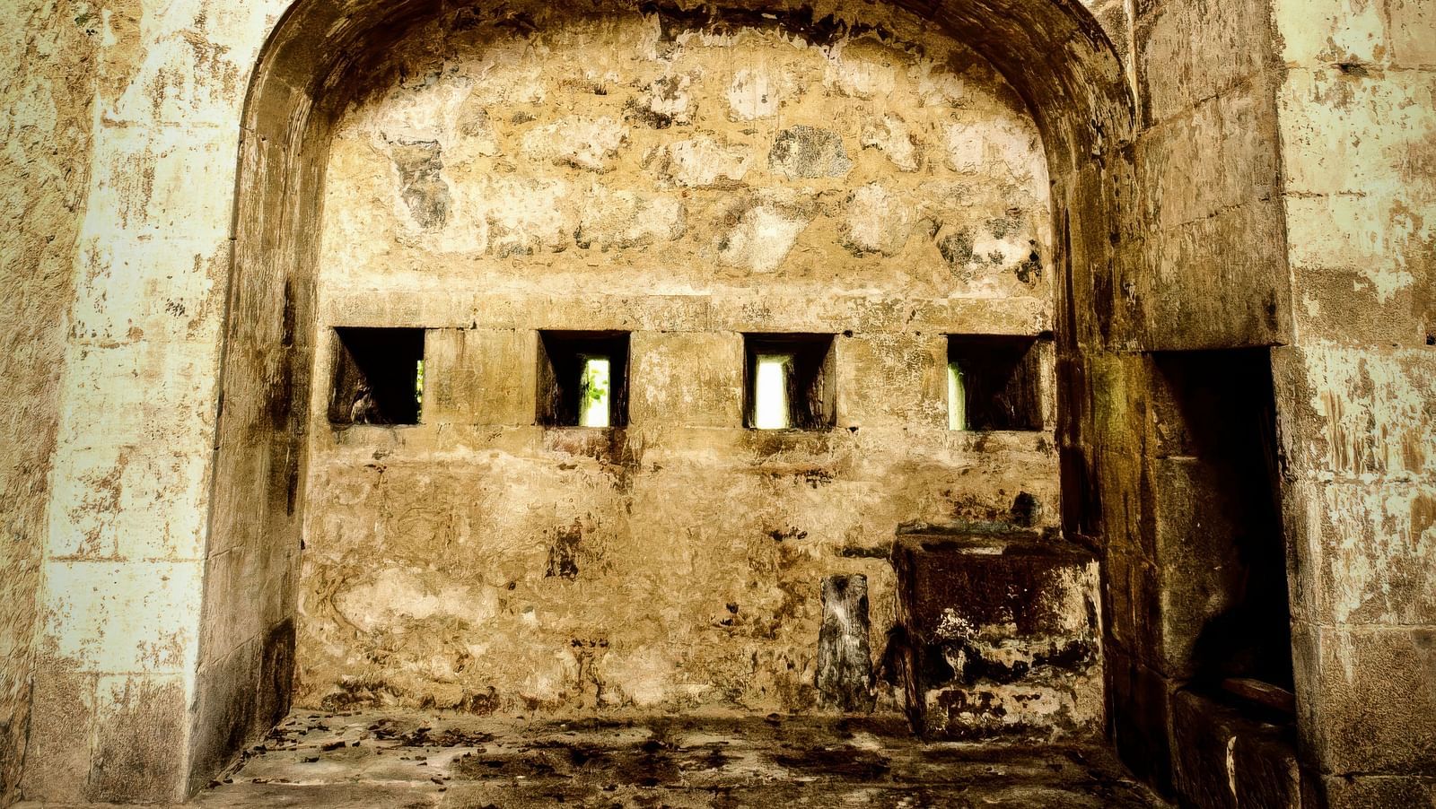 An overview of the interior of a fort with an arch and windows in view