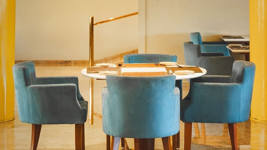 An image of seating area with sofa sets and a centre table placed in a room -  The Garden Ananta Elite, Rajkot
