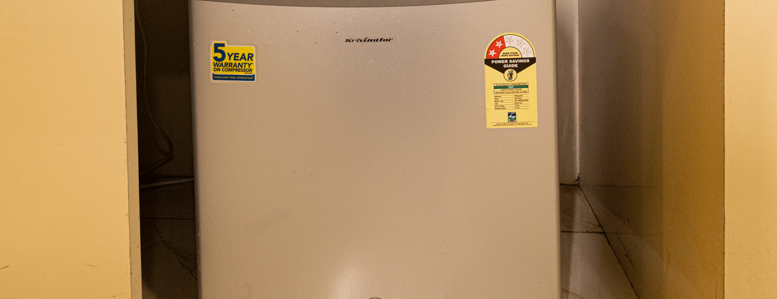 A mini refrigerator placed inside a built-in shelf at Hotel Seagull Digha.