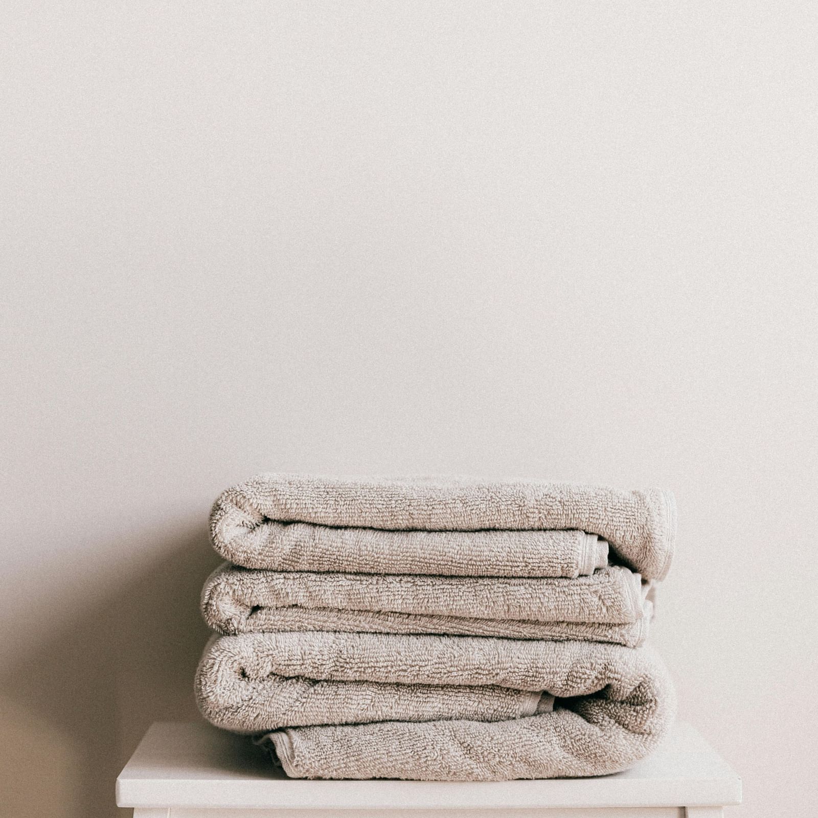 folded towels are kept on a stool