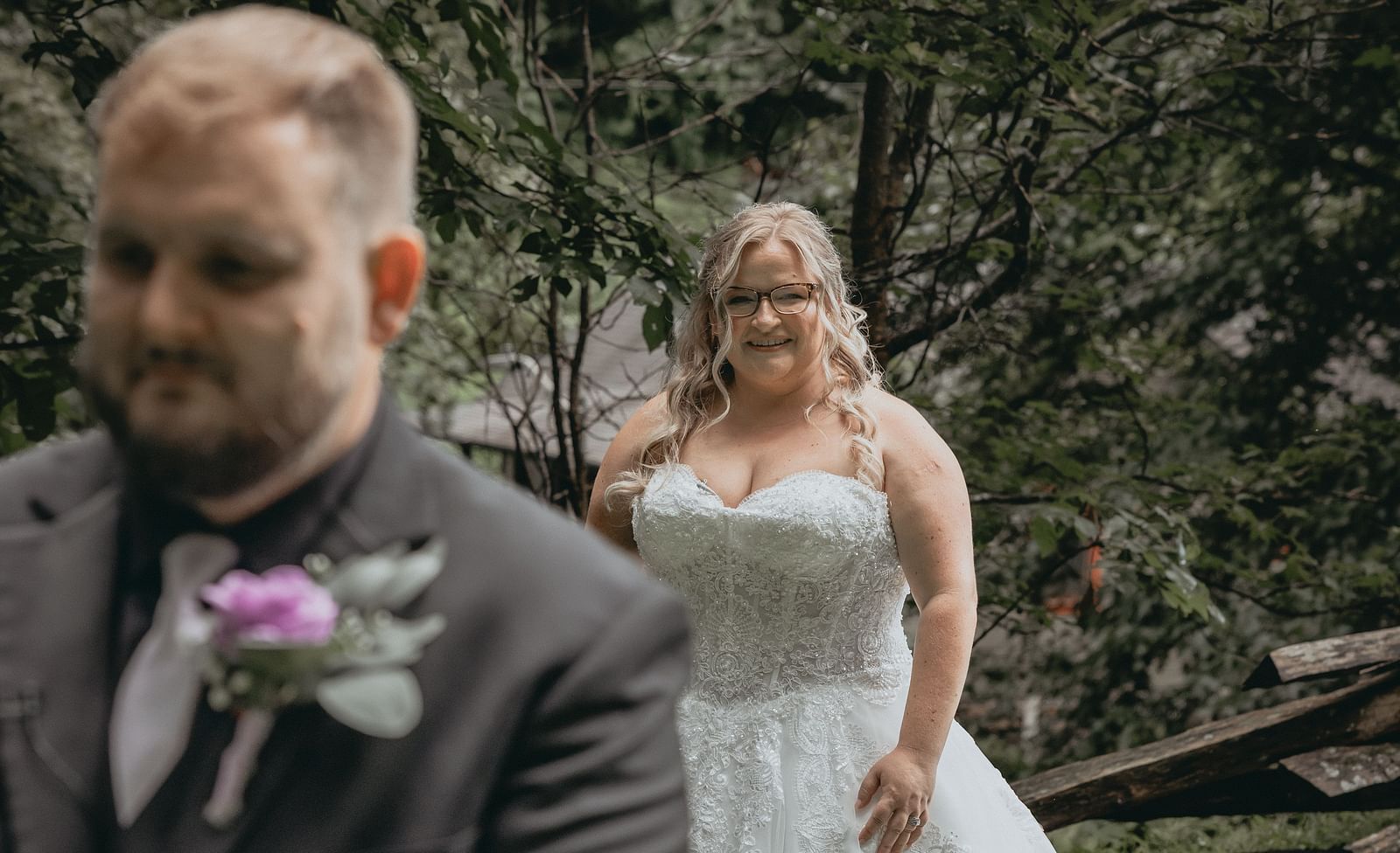Bride standing behind her to be husband, meaning to pose for their wedding shoot at the Histpric Tapoco Lodge. 