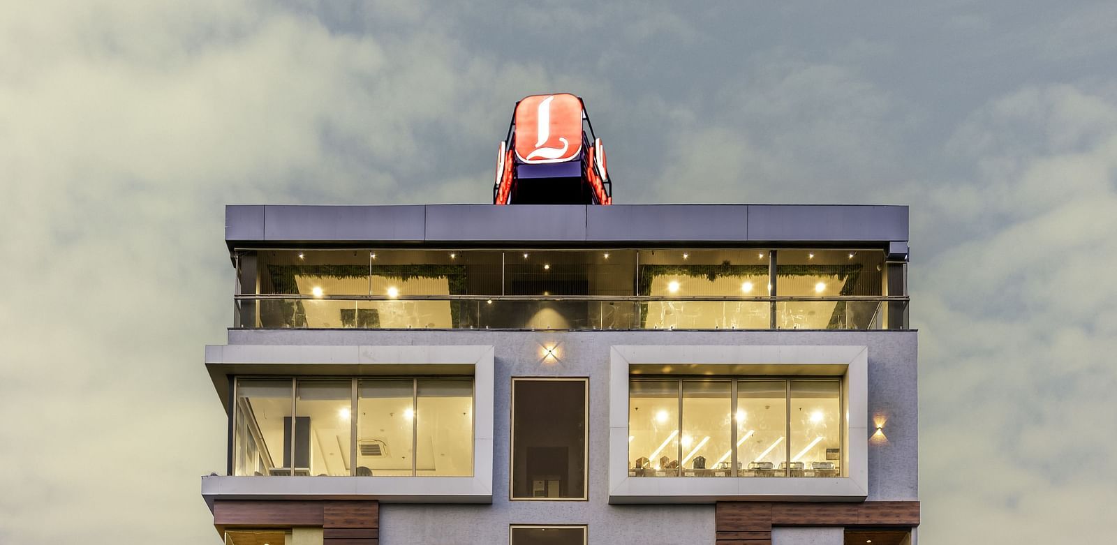 A clear, frontal view of a Lords Hotels & Resorts building with bright signage and symmetrical design.