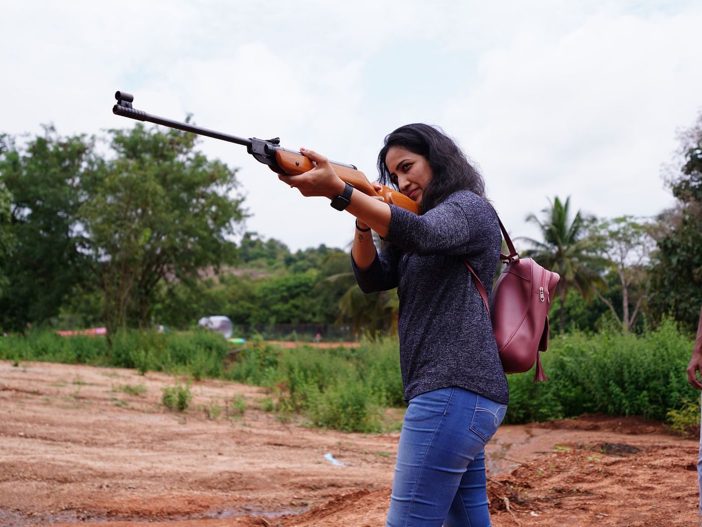 A woman holding a rifle for a shooting game at Ravishing Retreat 
