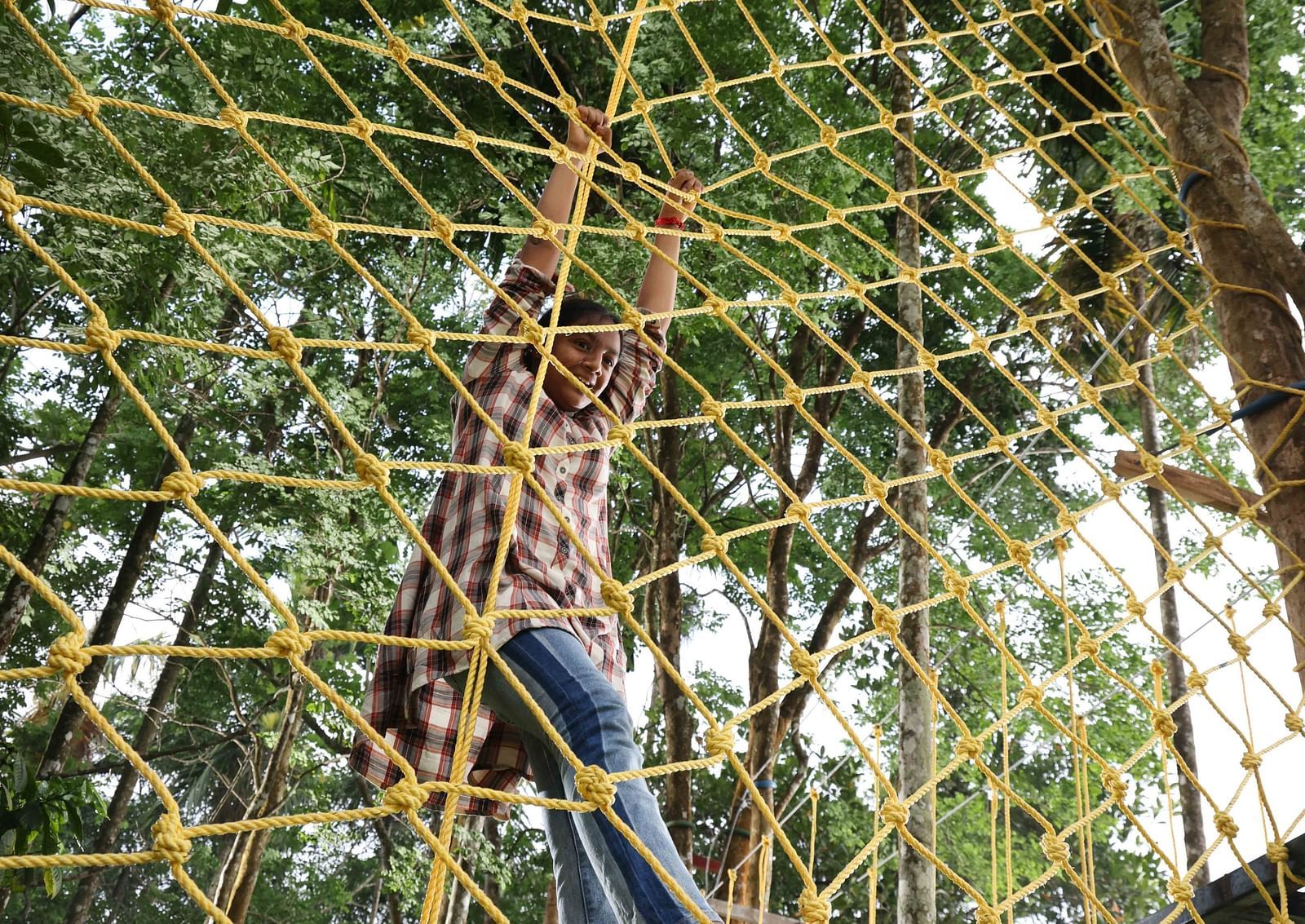 Image of a girl doing an adventurous activity at the hotel | Great Trails Wayanad by  GRT hotels.
