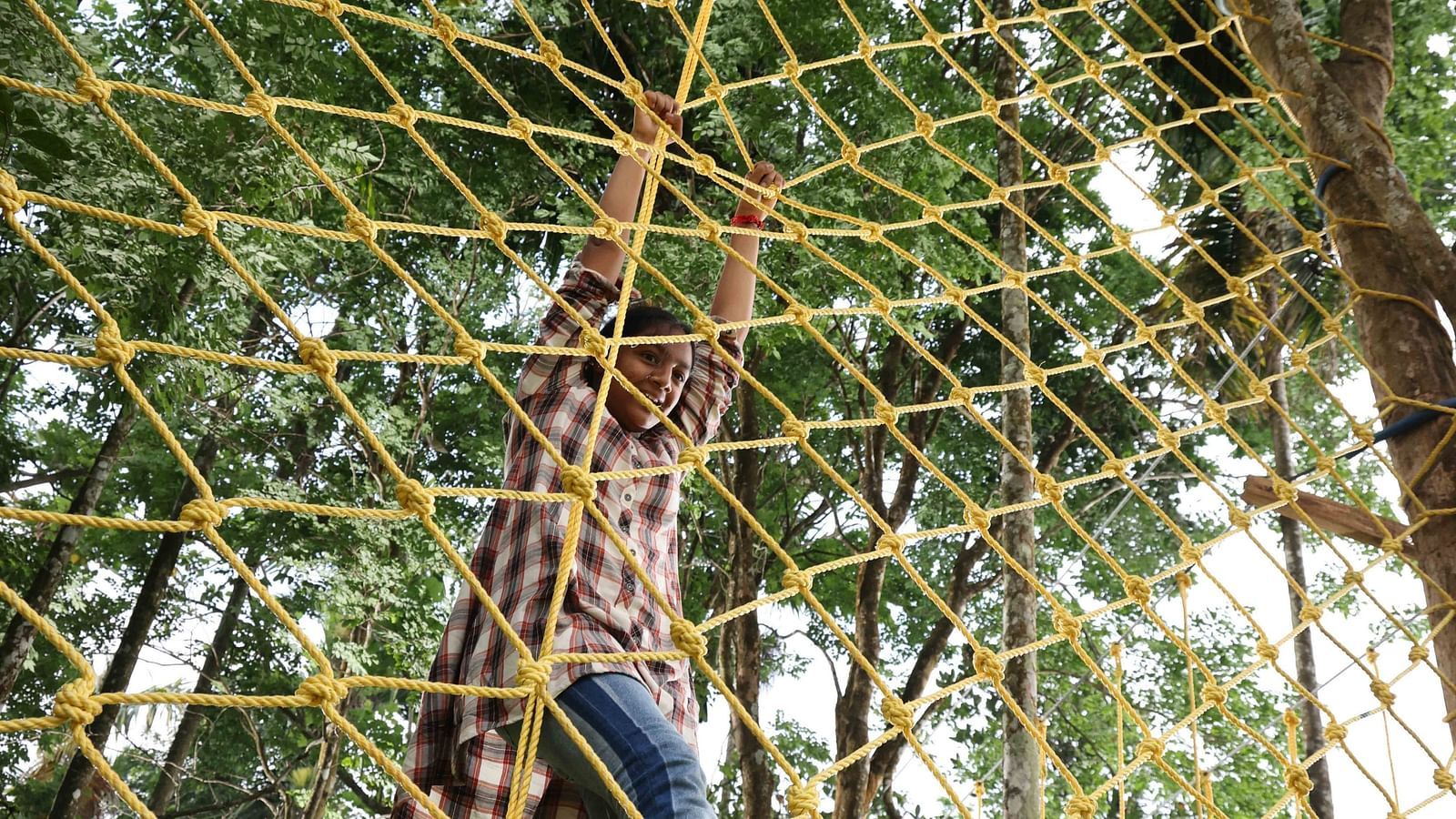 Image of a girl doing an adventurous activity at the hotel | Great Trails Wayanad by  GRT hotels.