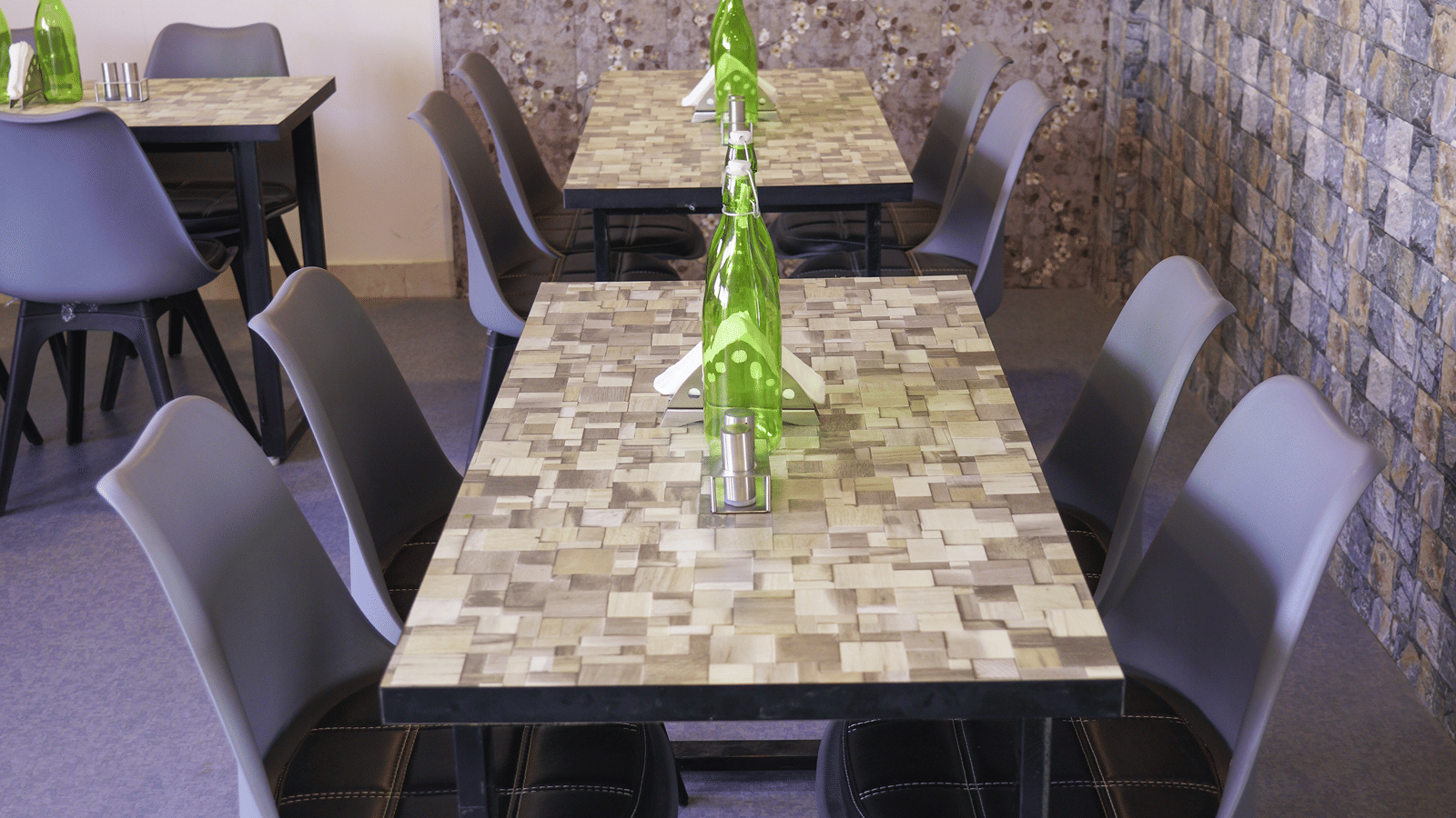 Dining area of Lime Tree Hotel, Pulkit featuring a table, chairs, and a window with floral wallpaper.