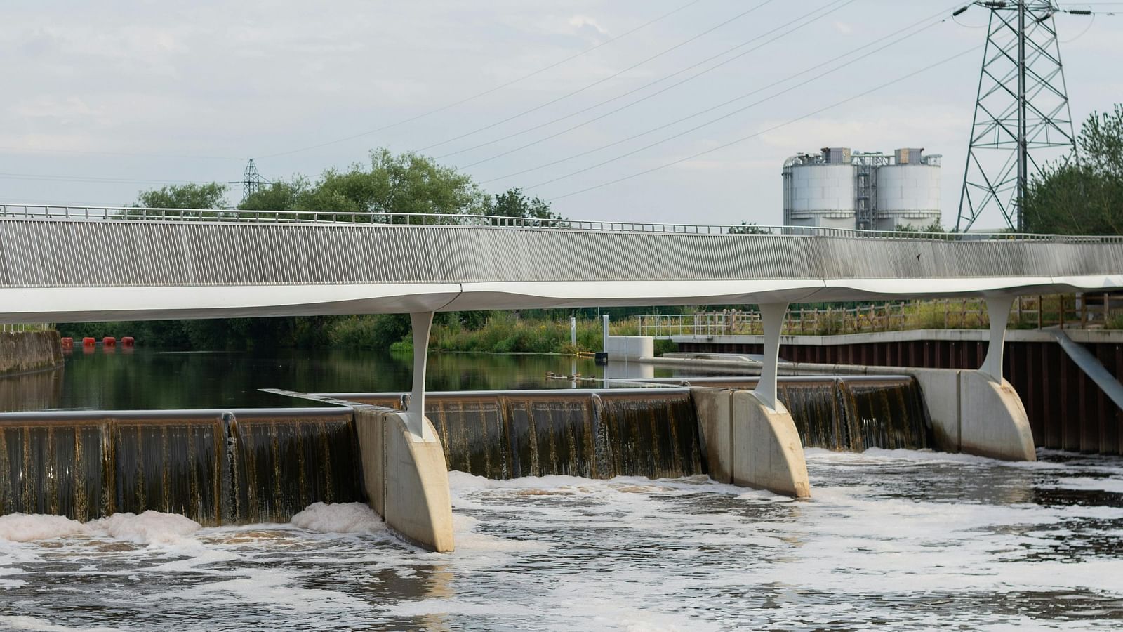 Open dam with flowing water cascading over the edge.