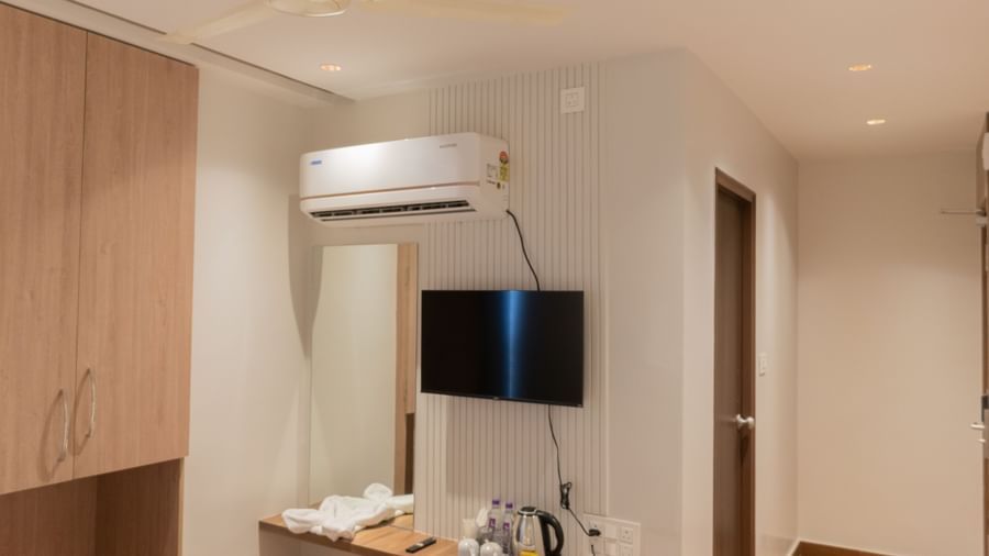 Comfortable bed with runner and stylish furnishing at Beestay Hotels, Rajahmundry.