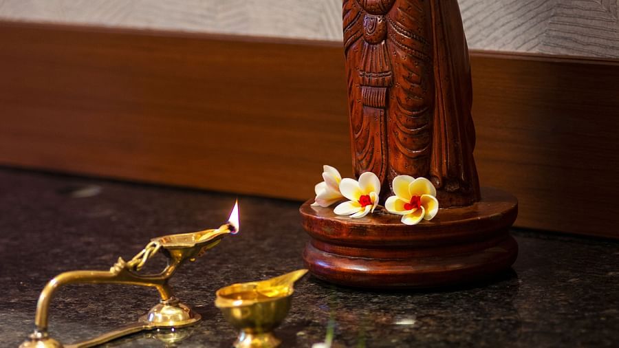 Gamyam Retreat, Kumta - A lit earthern lamp kept in front of a miniature statue of a deity