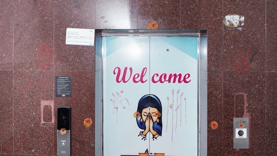 The elevator entrance at Hotel Vikram featuring a blue 'Welcome' sign with the hotel logo.
