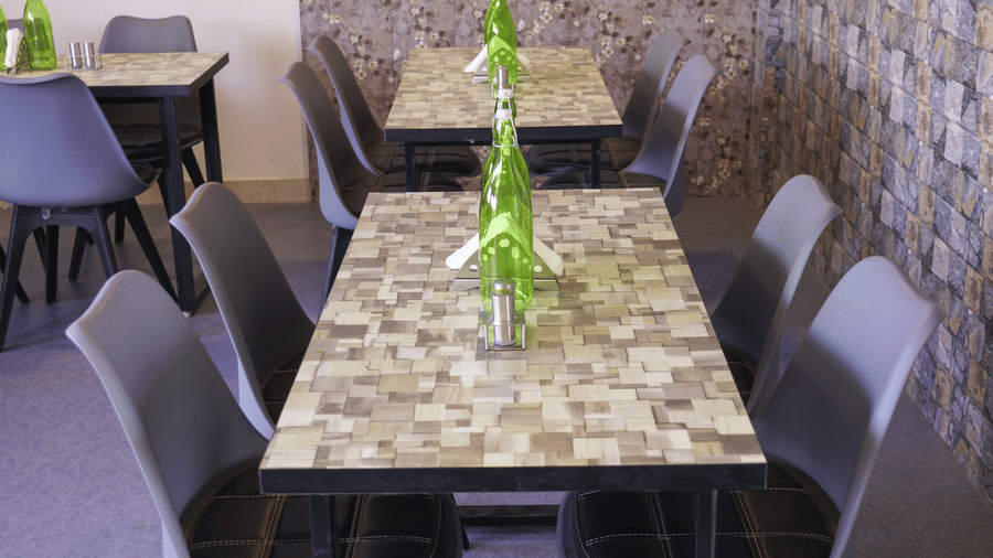 Dining area of Lime Tree Hotel, Pulkit featuring a table, chairs, and a window with floral wallpaper.