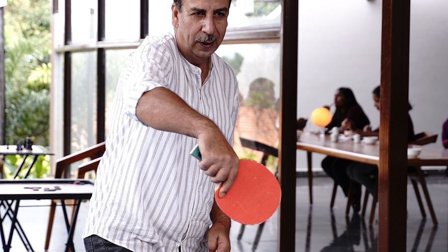 A person playing table tennis during daytime at Ravishing Retreat in Bangalore