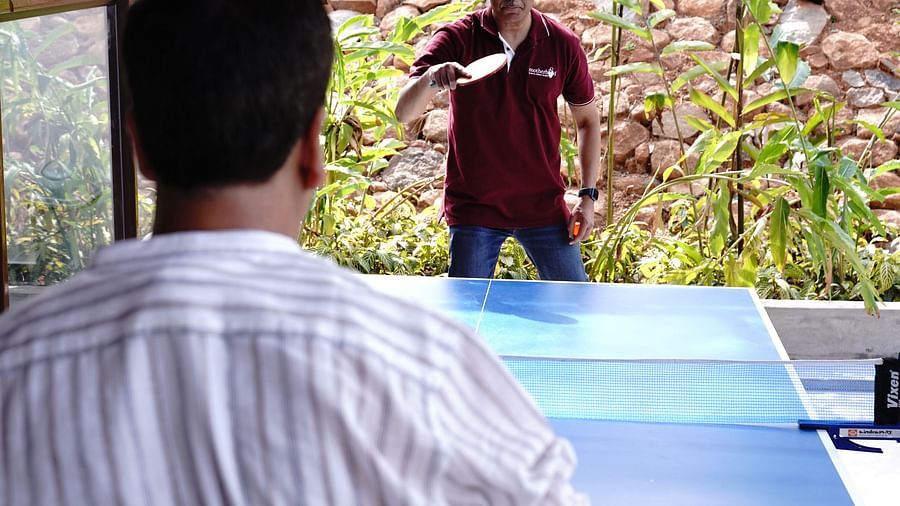 Two people playing table tennis at Ravishing Retreat in Bangalore