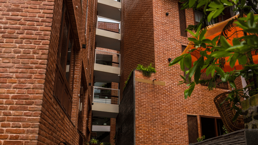 Exterior view of a narrow brick walkway and stone steps leading into a luxury heritage boutique hotel in Bhaktapur, Nepal.