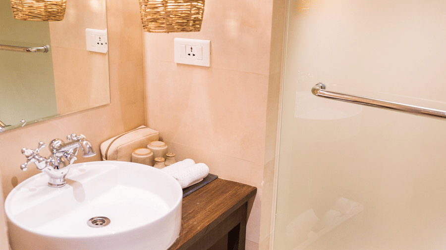 The washroom at The Nanee features toiletries and a bamboo chandelier.