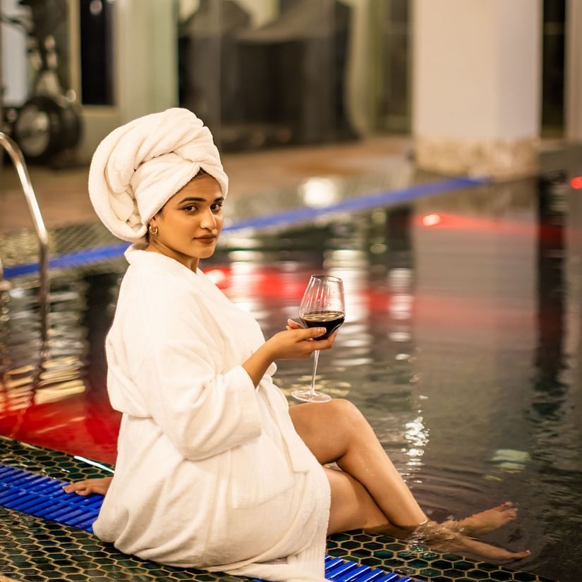 A image of a woman enjoying a drink near a pool  - The Manor Luxury Hotel, Shimla