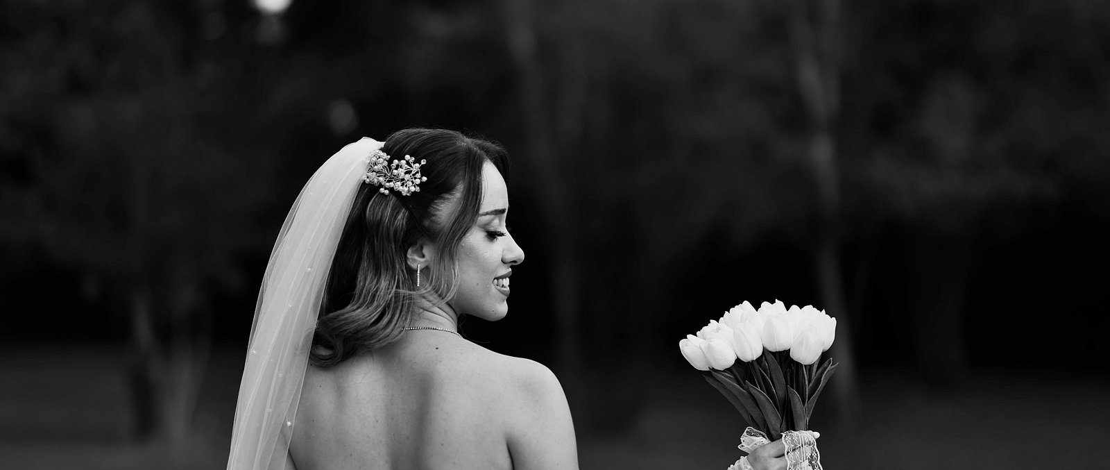 A bride posing with a bouquet for a photoshoot - The Groveland Hotel.