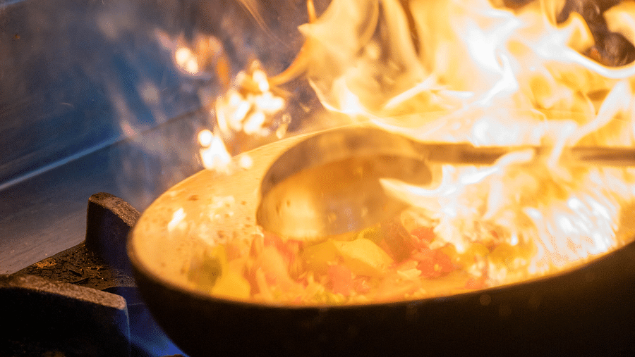 A dramatic flare-up while sauteing in a kitchen - Hotel Udai Median, Udaipur.