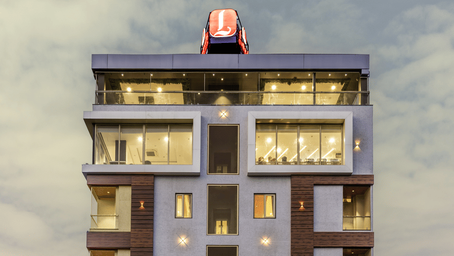 A clear, frontal view of a Lords Hotels & Resorts, best hotel in Sumerpur, Rajasthan, building with bright signage and symmetrical design.