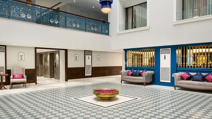 An image of our spacious lobby courtyard featuring colourful hanging lights and elegant decor - MJ Sarovar Portico, Haridwar