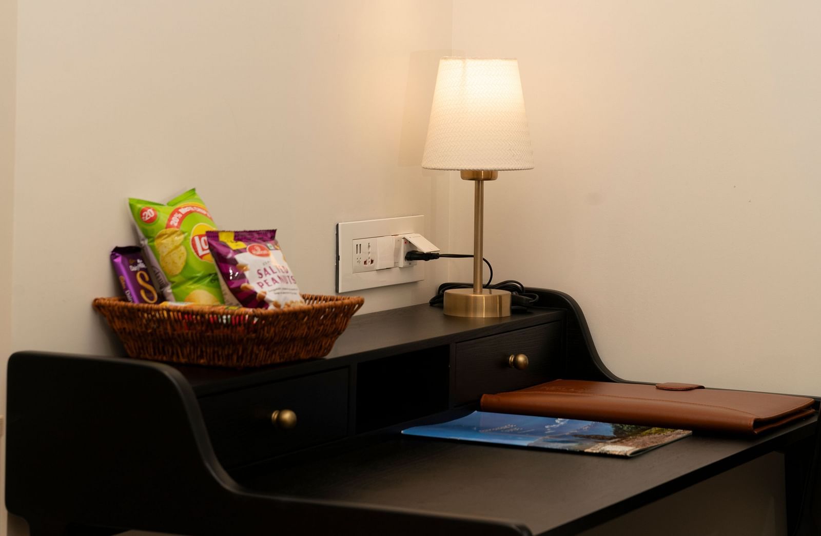 A minimalist study nook with a desk and lamp at Nivasana Manali.