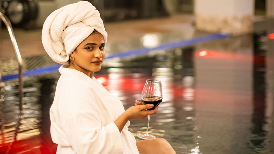 A image of a woman enjoying a drink near a pool  - The Manor Luxury Hotel, Shimla