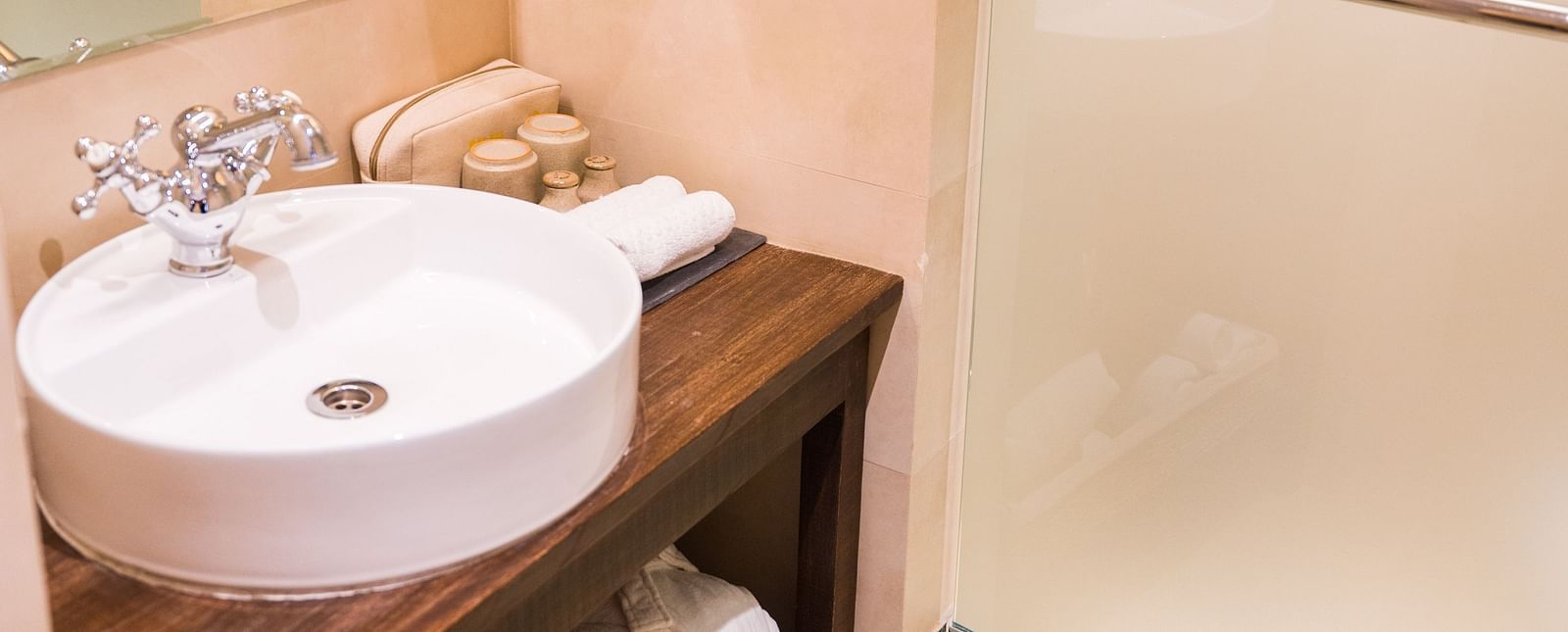 The washroom at The Nanee features toiletries and a bamboo chandelier.