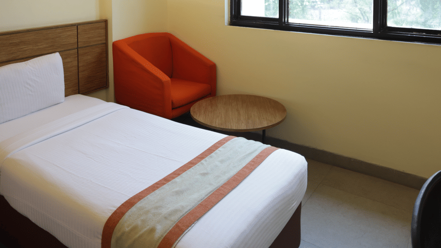 Tranquil Max Club Room, offering a perfect blend of modern design and peaceful surroundings with big windows and plenty of natural light.