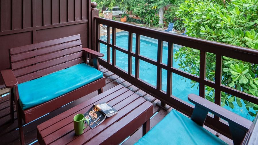 Thai Cottage Balcony with a table and sofa
