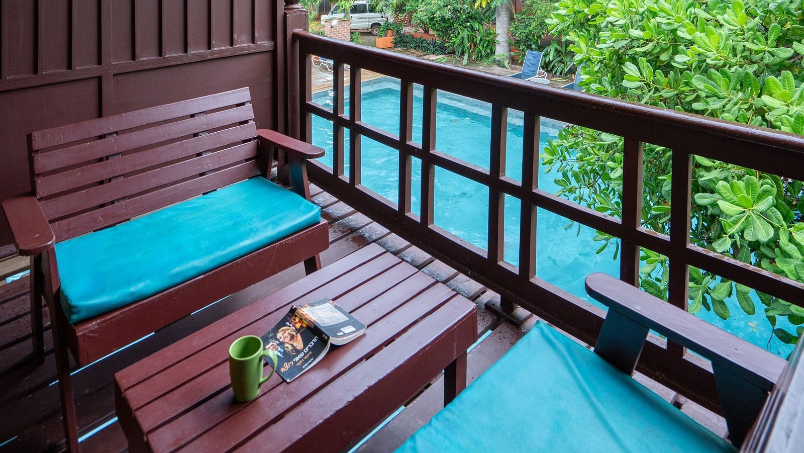 Thai Cottage Balcony with a table and sofa