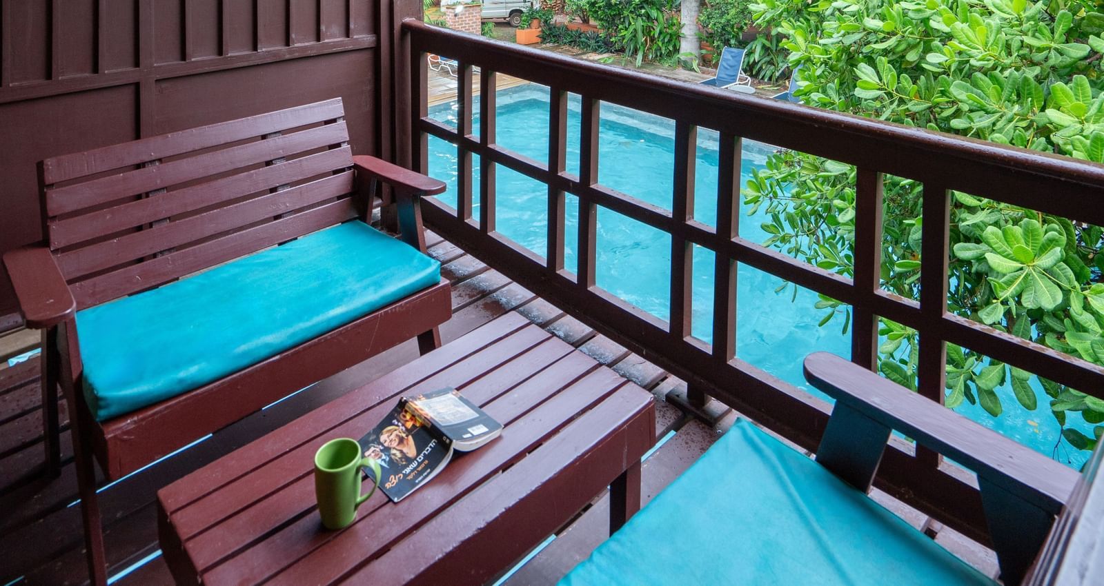 Thai Cottage Balcony with a table and sofa