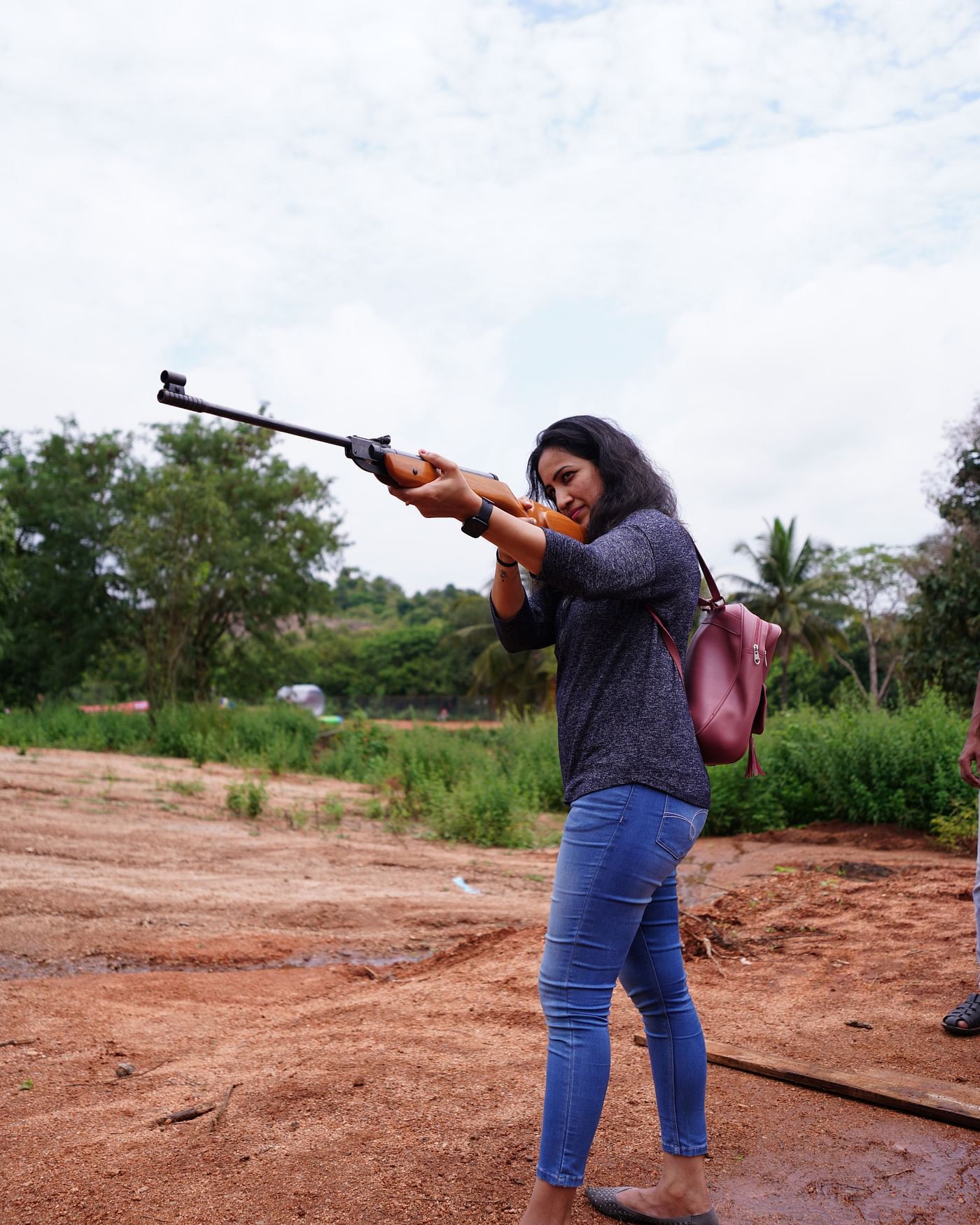 A woman holding a rifle for a shooting game at Ravishing Retreat 