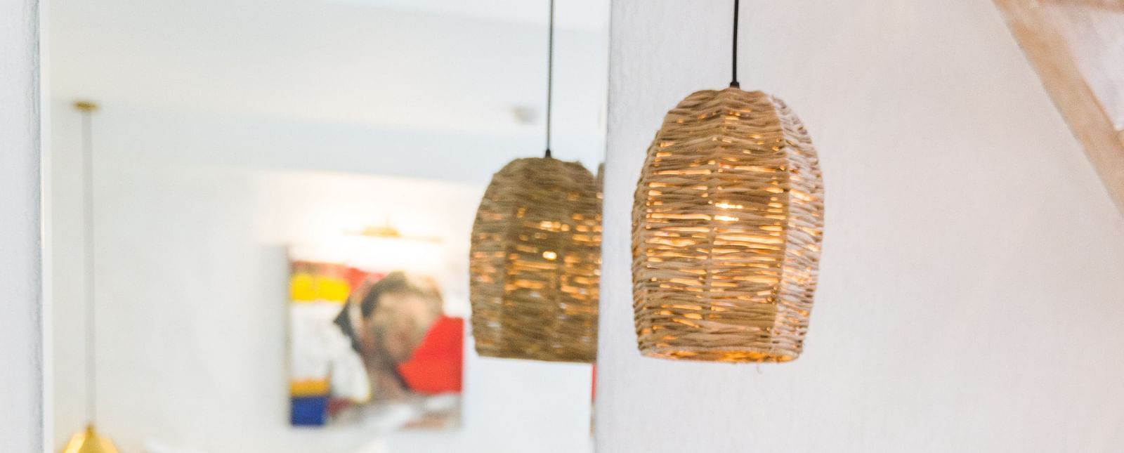 Deluxe loft room washroom area with a bamboo lamp hanging from the ceiling - The Nanee