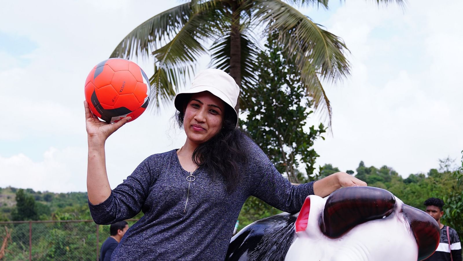 A woman standing next to the mechanical bull game holding a ball at Ravishing Retreat 