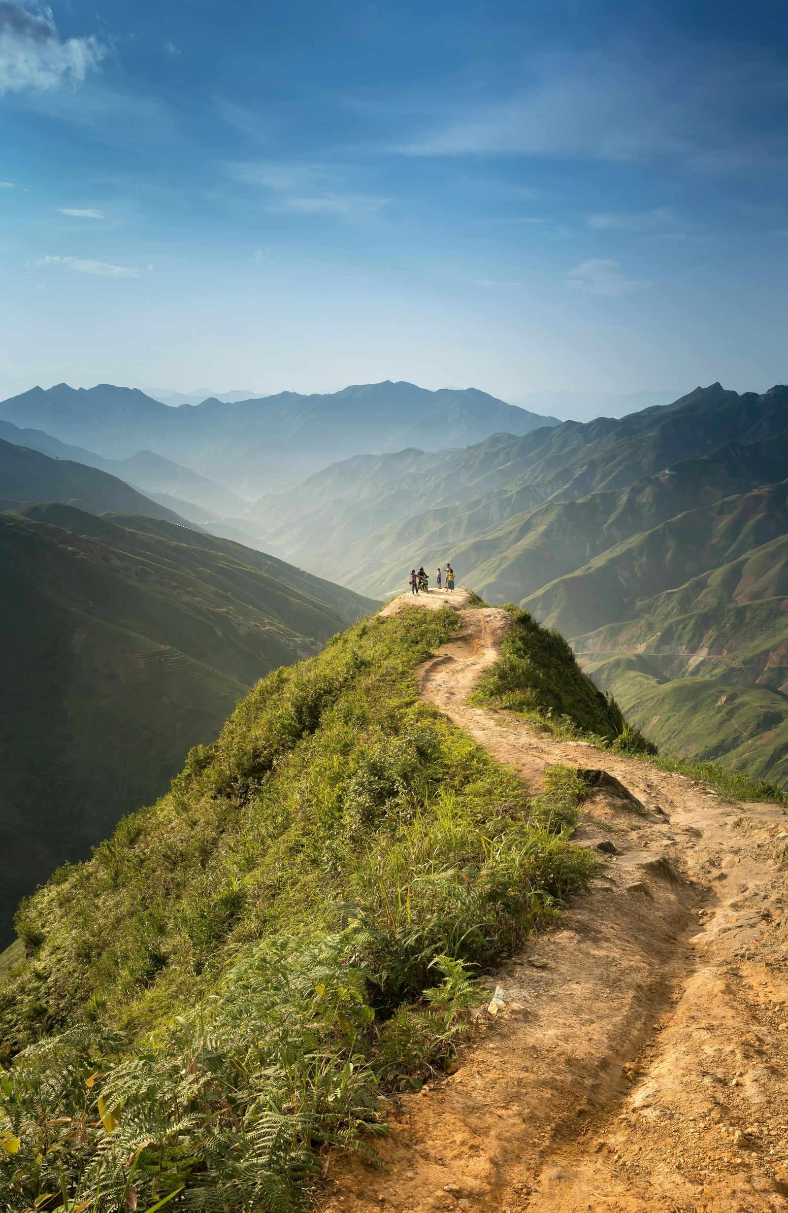 A trail leading to the edge of a cliff overlooking a valley