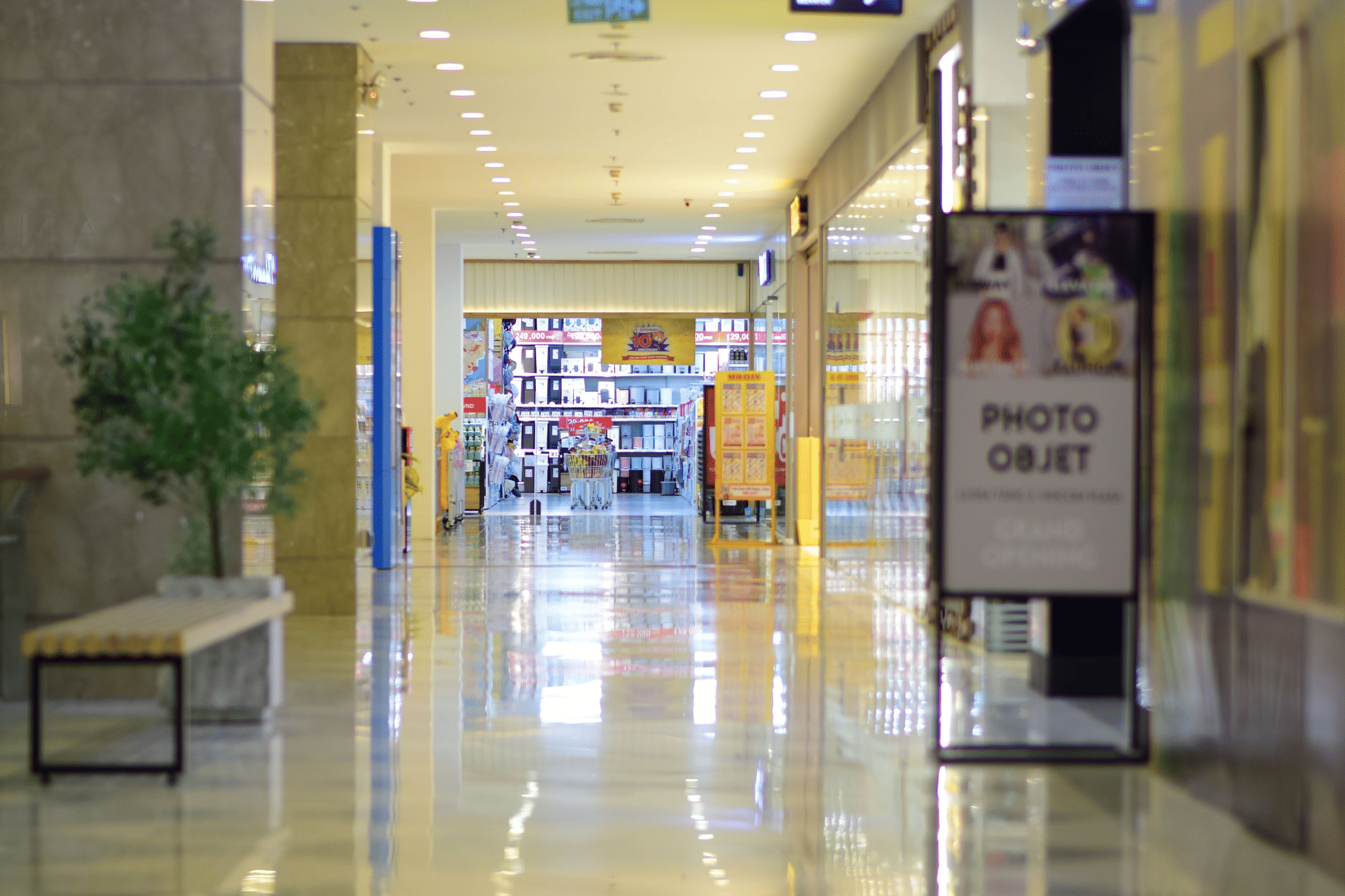 Bright shopping corridor lined with stores at a mall in Coimbatore