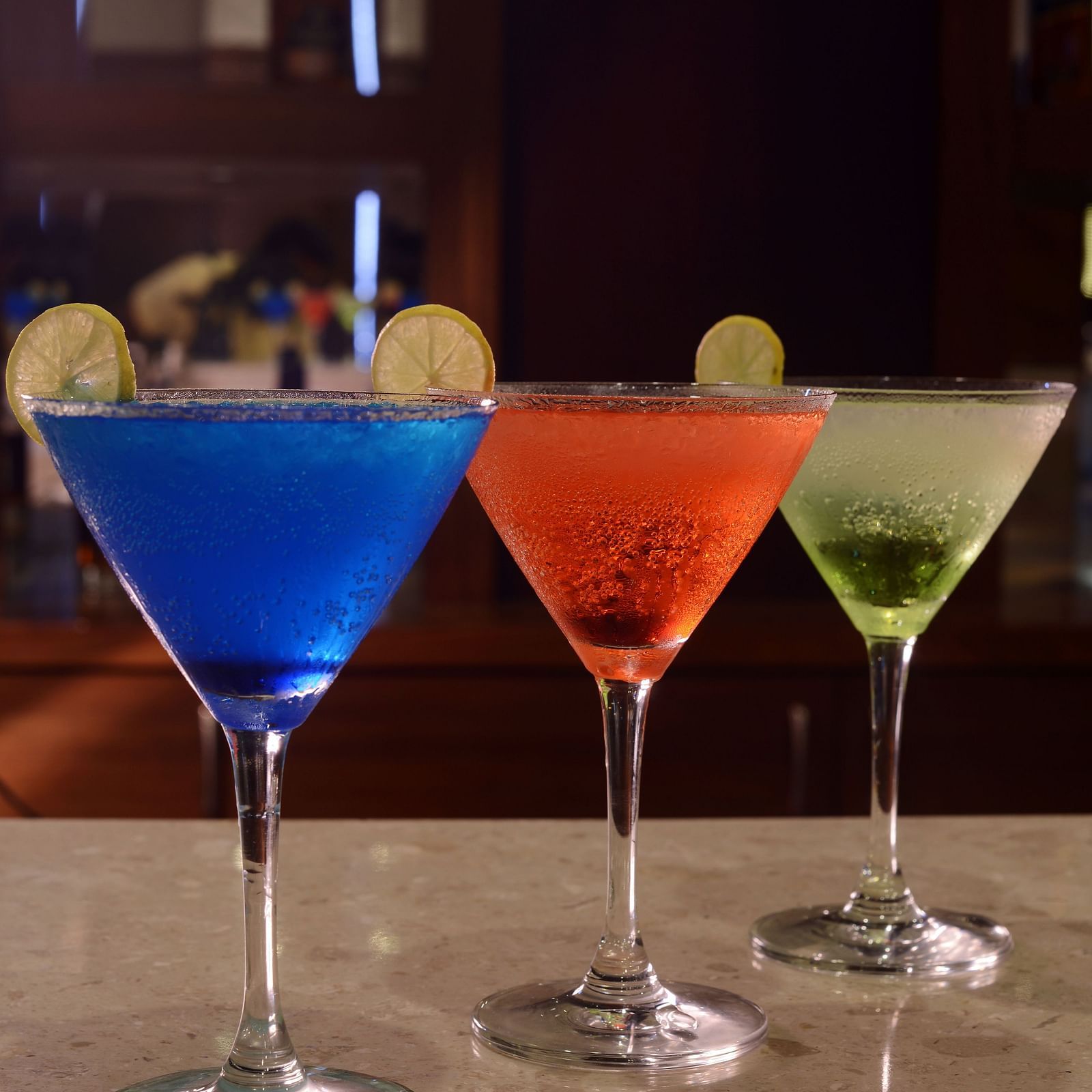 Three martini glasses with drinks and with twists